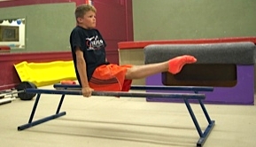 young boy parallel bars